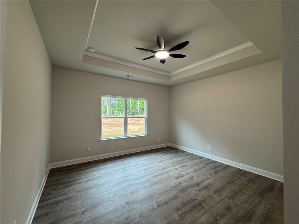 2113 North Hicks Road Toccoa, GA 30577 - Photo 10 of 28 an empty room with wooden floor fan and windows