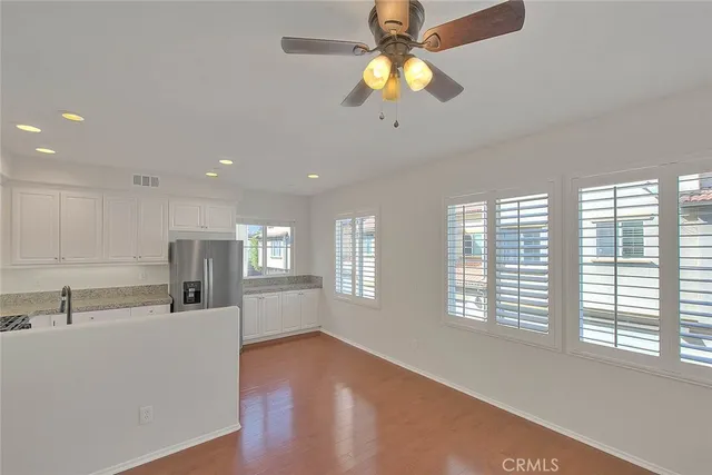 a kitchen with granite countertop white cabinets and stainless steel appliances
