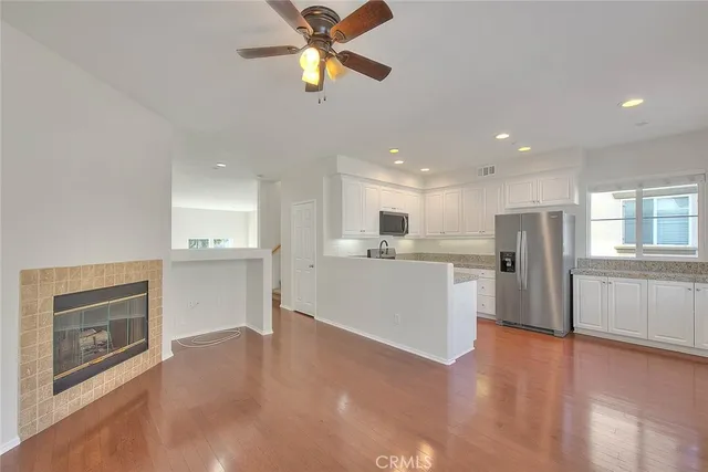 a kitchen with sink a microwave and cabinets