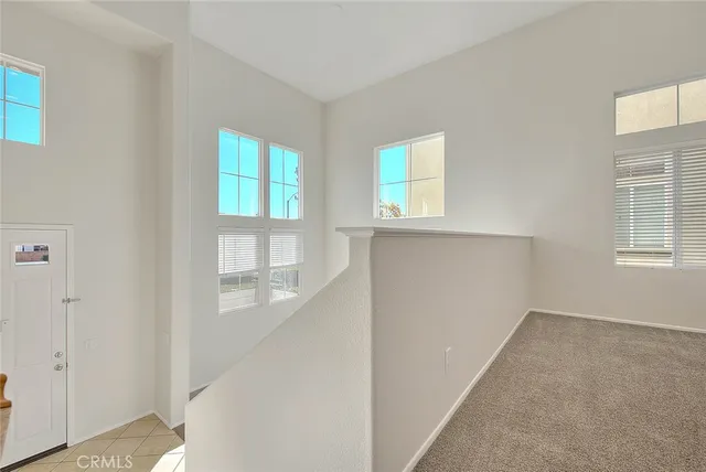 a view of an empty room with window and cabinet