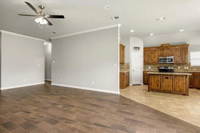 a view of kitchen with refrigerator stove and microwave