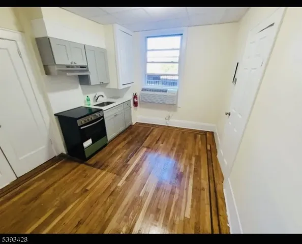a kitchen with wooden floors and white appliances