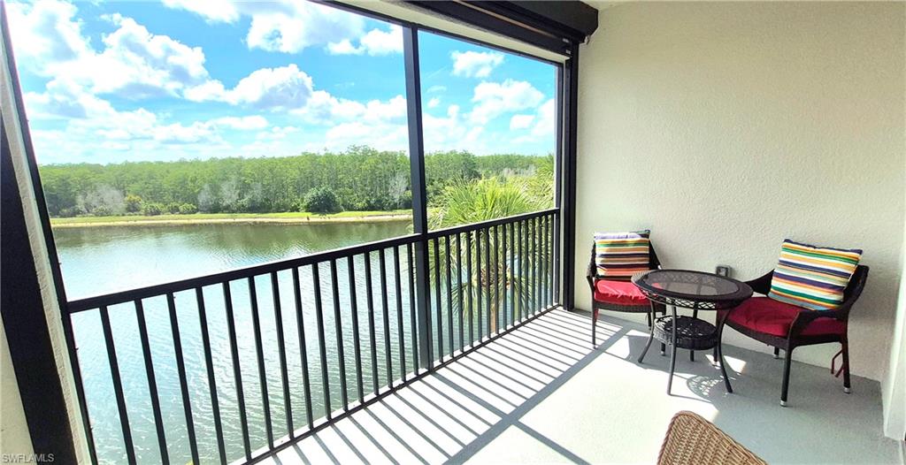 9566 Trevi Court, Unit 4943 Naples, FL 34113 - Photo 1 of 47 a view of a balcony with chair and wooden floor