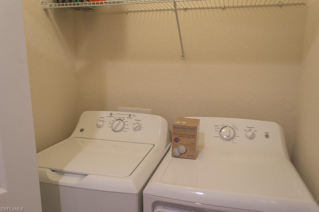 9566 Trevi Court, Unit 4943 Naples, FL 34113 - Photo 11 of 33 a utility room with dryer and washer