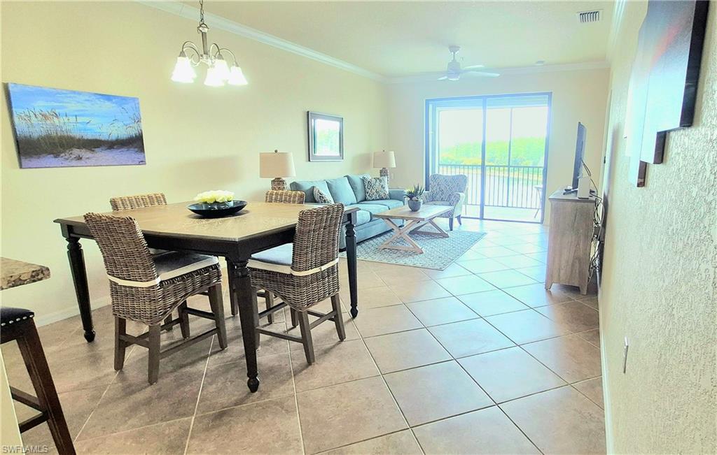 9566 Trevi Court, Unit 4943 Naples, FL 34113 - Photo 11 of 47 a view of a dining room with furniture and a chandelier