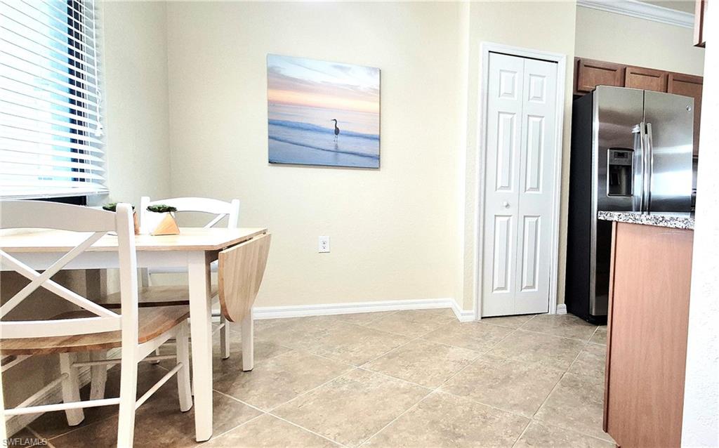 9566 Trevi Court, Unit 4943 Naples, FL 34113 - Photo 13 of 47 a view of a room that has a dining table and chairs