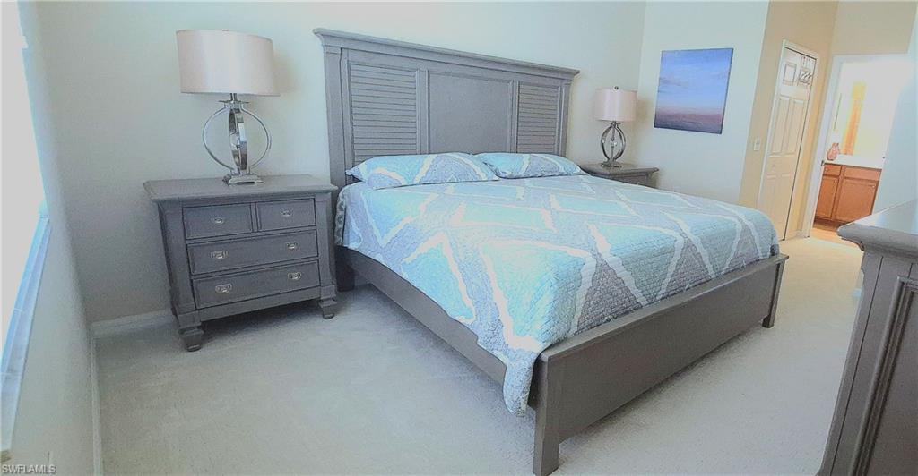 9566 Trevi Court, Unit 4943 Naples, FL 34113 - Photo 17 of 47 a bedroom with a bed and a window