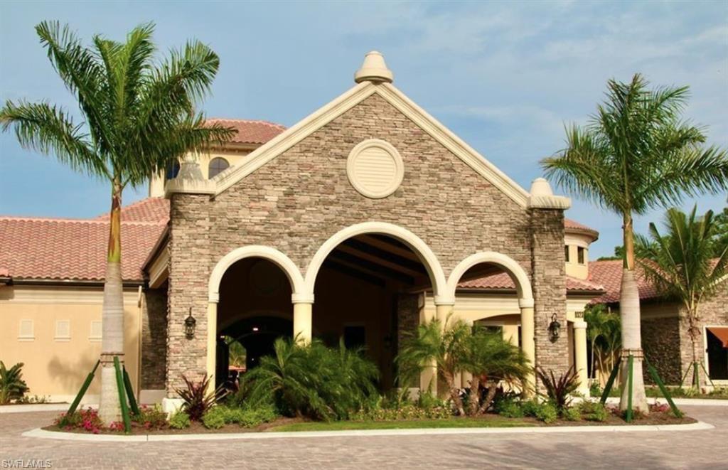 9566 Trevi Court, Unit 4943 Naples, FL 34113 - Photo 17 of 33 a view of a grey house with a yard