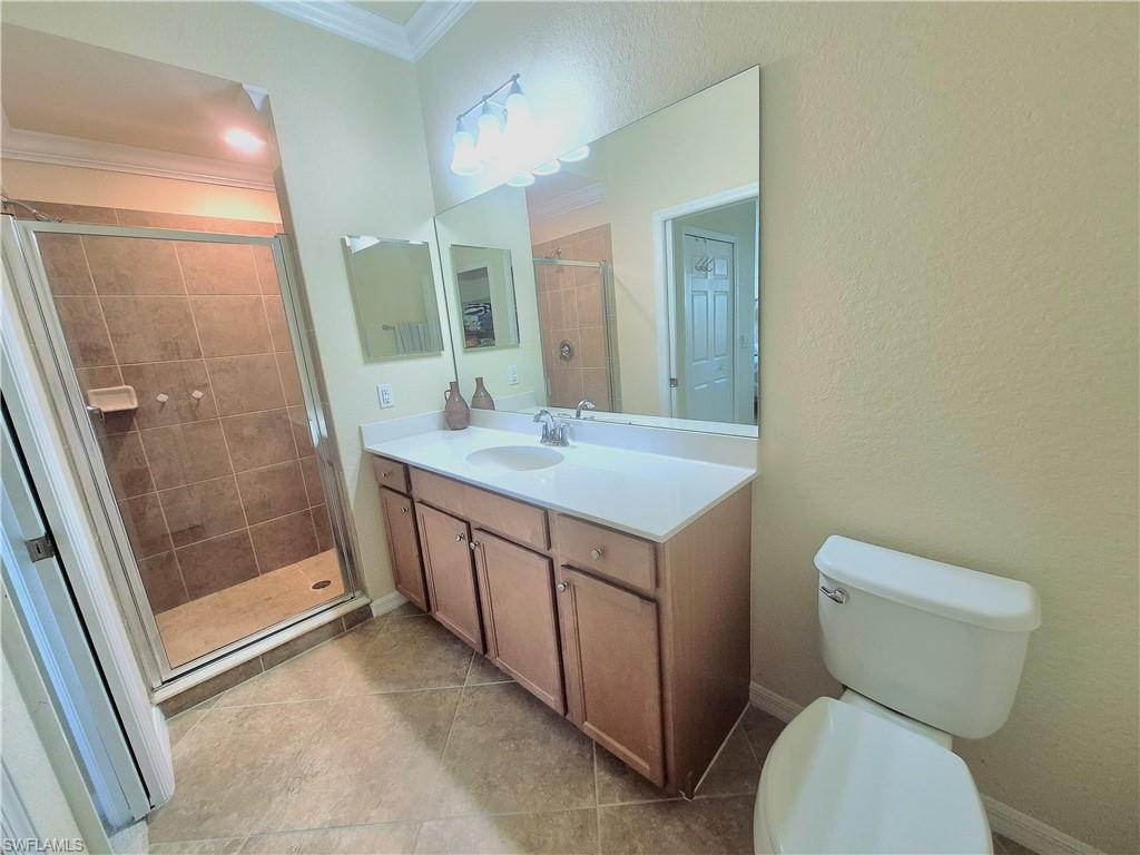 9566 Trevi Court, Unit 4943 Naples, FL 34113 - Photo 21 of 47 a bathroom with a sink a toilet and shower
