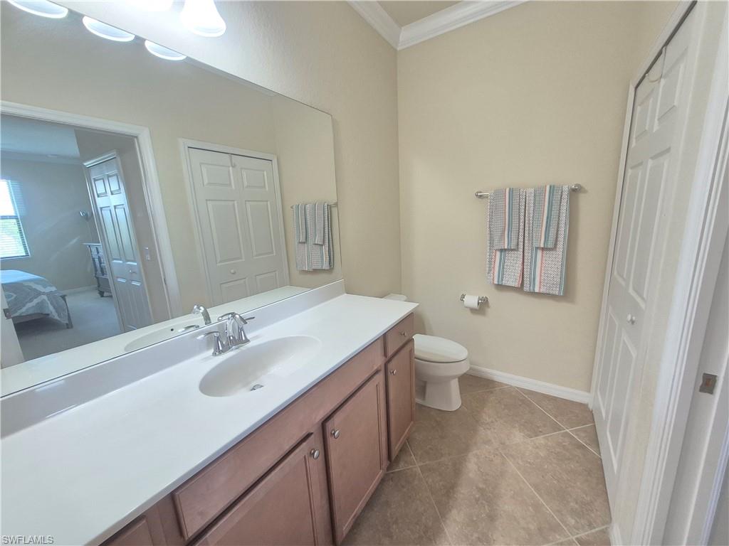 9566 Trevi Court, Unit 4943 Naples, FL 34113 - Photo 23 of 47 a bathroom with a granite countertop sink toilet and shower