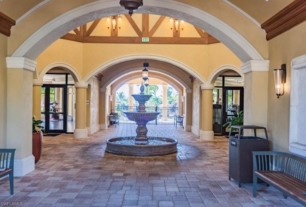 9566 Trevi Court, Unit 4943 Naples, FL 34113 - Photo 28 of 47 a view of swimming pool with a fireplace and dining table