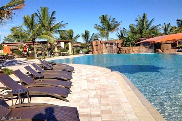 9566 Trevi Court, Unit 4943 Naples, FL 34113 - Photo 29 of 47 a view of a swimming pool with lounge chair