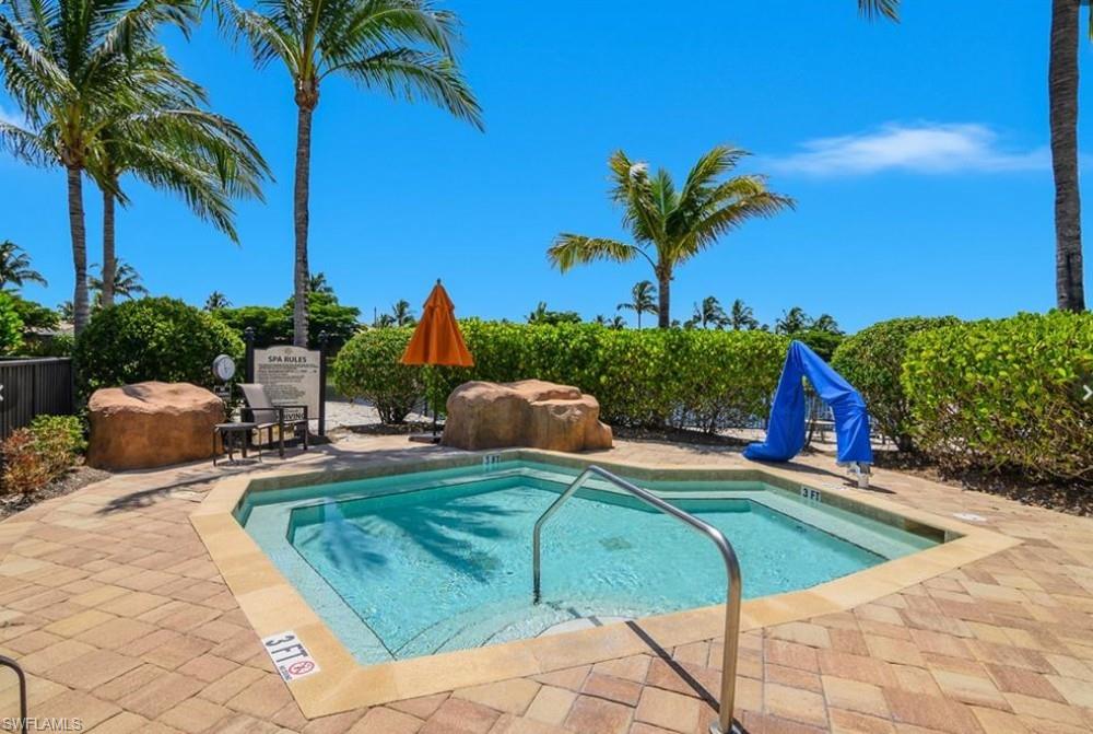 9566 Trevi Court, Unit 4943 Naples, FL 34113 - Photo 35 of 47 a view of a backyard with plants and palm tree