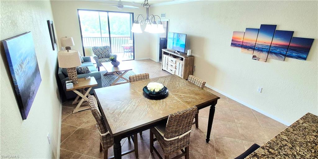 9566 Trevi Court, Unit 4943 Naples, FL 34113 - Photo 10 of 47 a view of a dining room with furniture window and outside view
