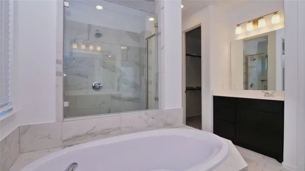 a bathroom with a bathtub and a shower