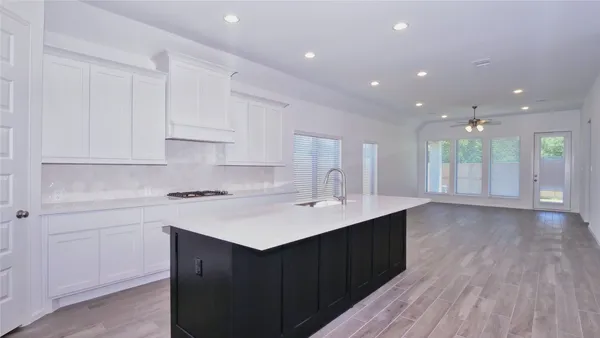 a kitchen with a sink stove and cabinets