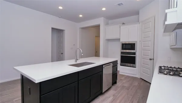 a kitchen with a sink and refrigerator