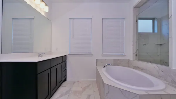 a bathroom with a bathtub and a sink