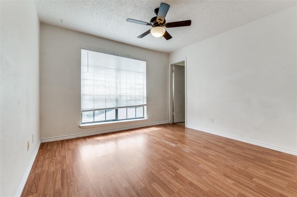 11655 Audelia Road, Unit 901 Dallas, TX 75243 - Photo 16 of 23 an empty room with wooden floor and windows