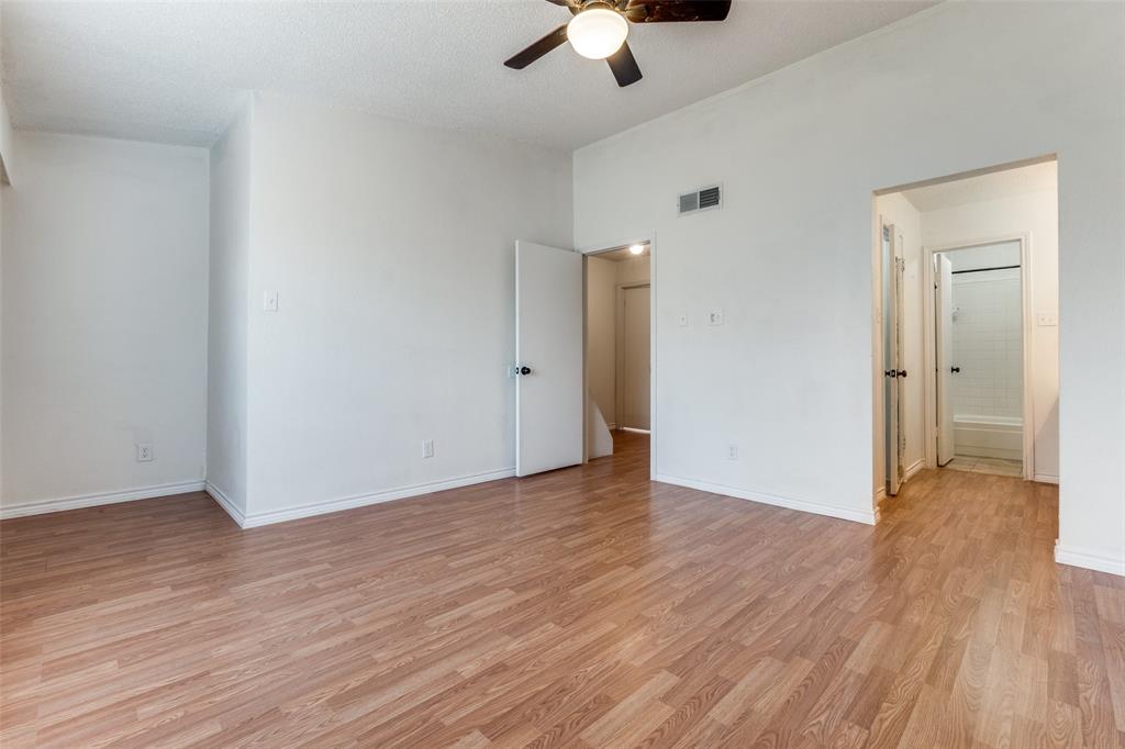 11655 Audelia Road, Unit 901 Dallas, TX 75243 - Photo 20 of 23 an empty room with wooden floor cabinet and a ceiling fan