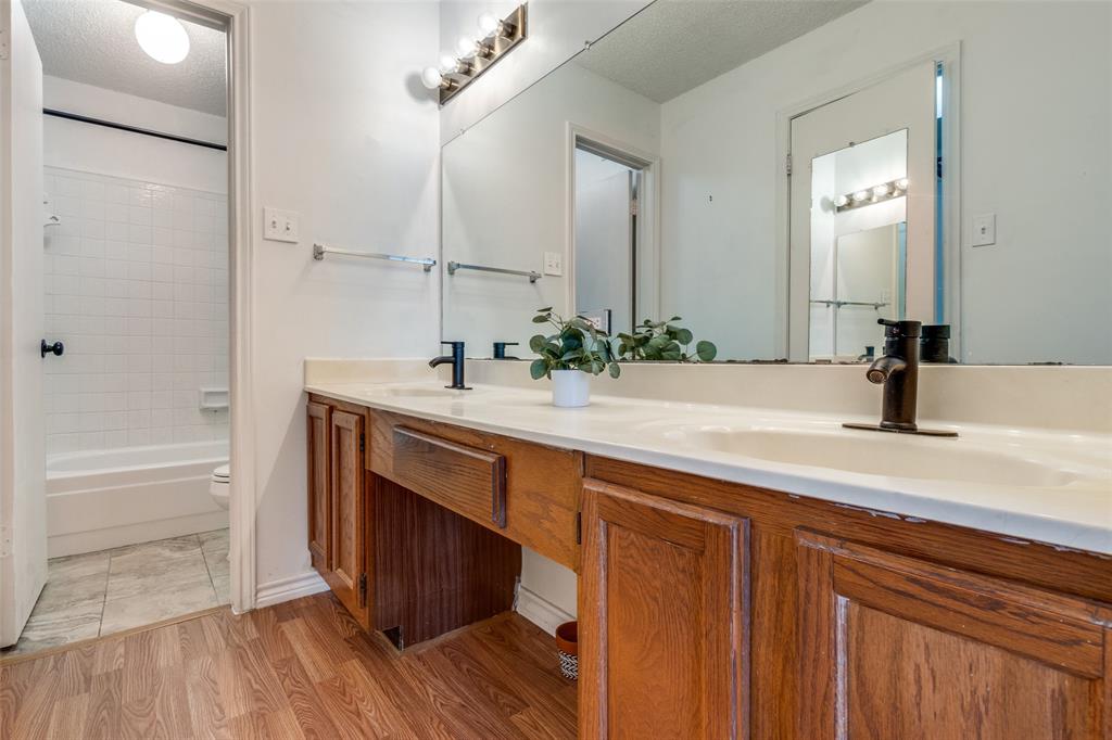 11655 Audelia Road, Unit 901 Dallas, TX 75243 - Photo 21 of 23 a bathroom with a sink and a mirror