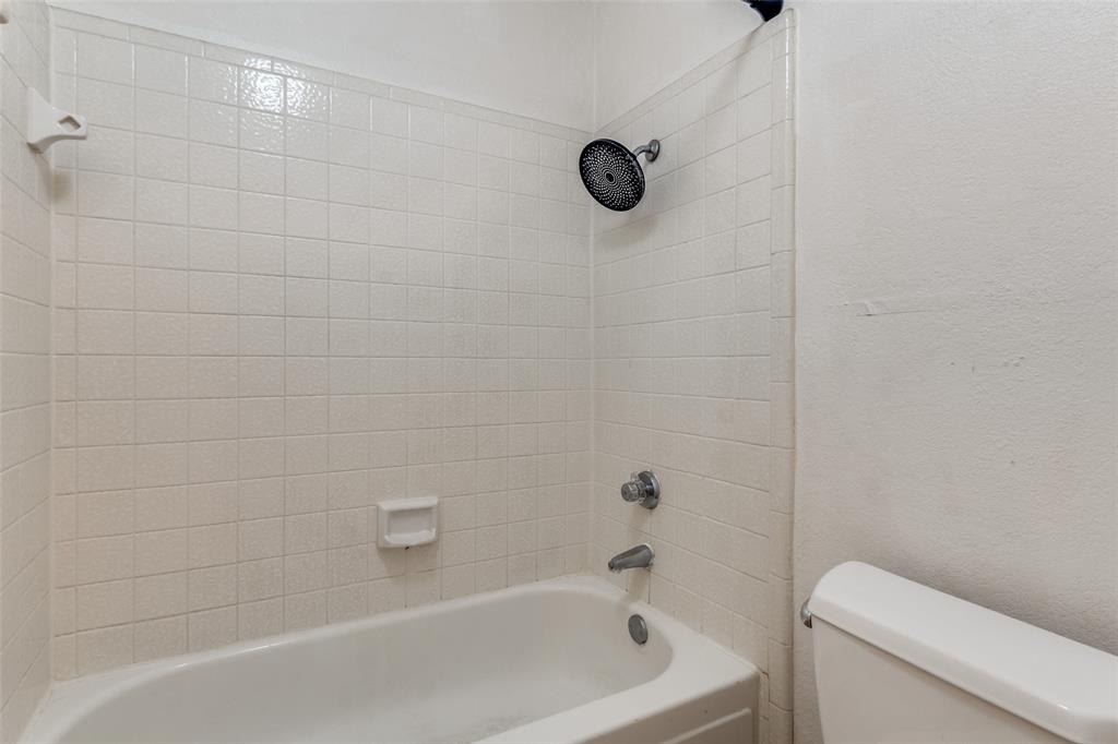 11655 Audelia Road, Unit 901 Dallas, TX 75243 - Photo 22 of 23 a bathroom with a bathtub and a shower