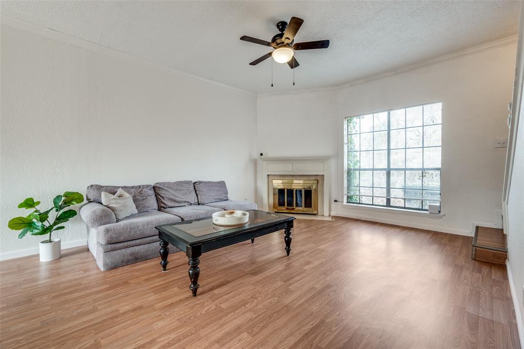 11655 Audelia Road, Unit 901 Dallas, TX 75243 - Photo 6 of 23 a living room with furniture and a fireplace
