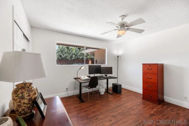 a work room with furniture and wooden floor