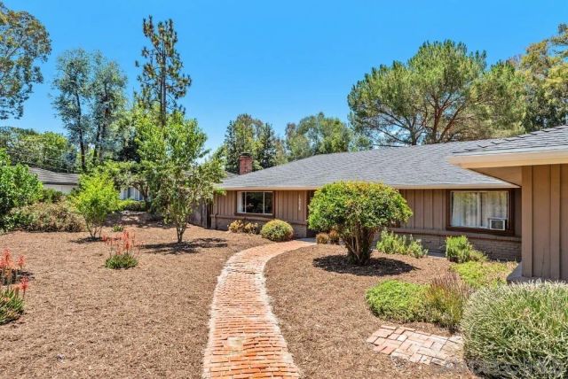 a front view of a house with yard