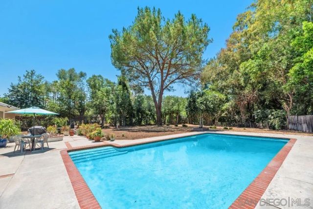 a view of a swimming pool and lounge chairs