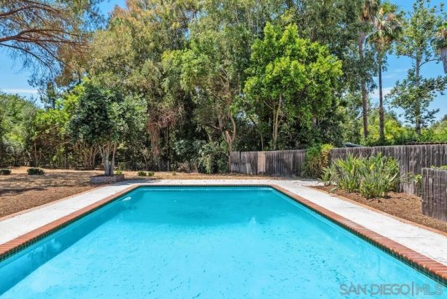 a view of a backyard with swimming pool