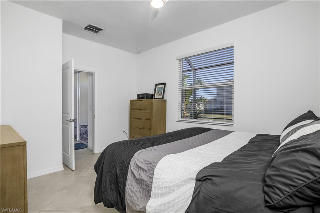2215 Dragonfruit Way Naples, FL 34120 - Photo 19 of 30 a bedroom with a bed and a window