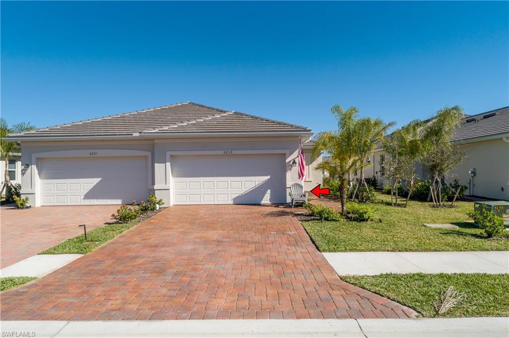2215 Dragonfruit Way Naples, FL 34120 - Photo 2 of 30 a view of a house with a yard and potted plants