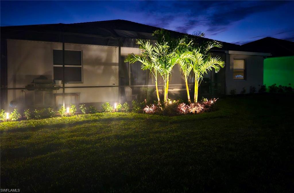2215 Dragonfruit Way Naples, FL 34120 - Photo 26 of 30 a front view of a house with garden