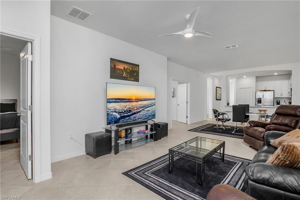 2215 Dragonfruit Way Naples, FL 34120 - Photo 8 of 30 a living room with furniture and a flat screen tv