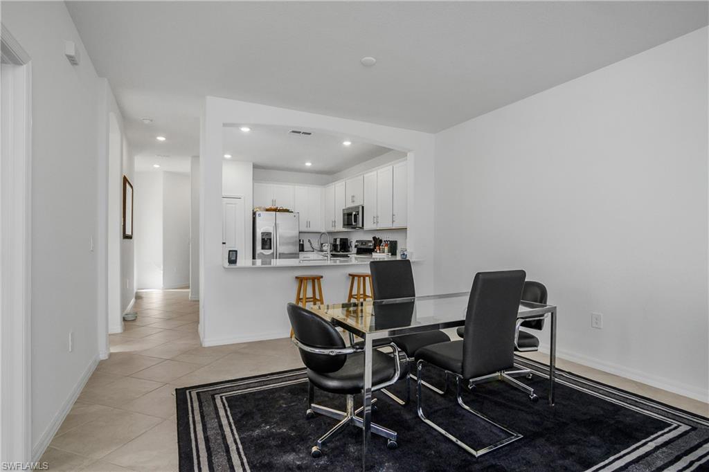 2215 Dragonfruit Way Naples, FL 34120 - Photo 10 of 30 a dining room with furniture and a view of kitchen