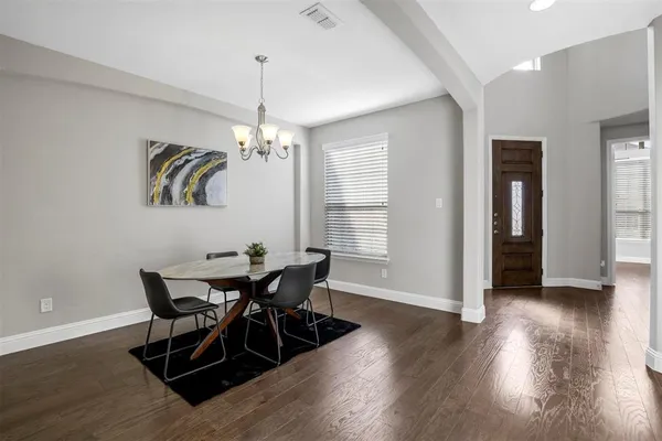 a view of a dining room with furniture and wooden floor