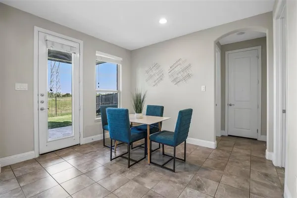 a view of a dining room with furniture and a window