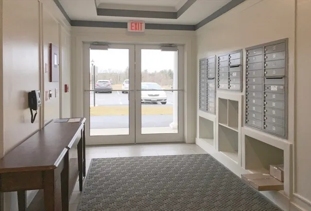 a view of a hallway with furniture and front door