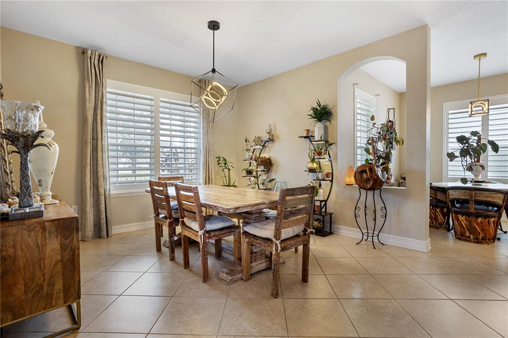 6911 Beargrass Road Harmony, FL 34773 - Photo 11 of 60 a view of a dining room with furniture and a chandelier
