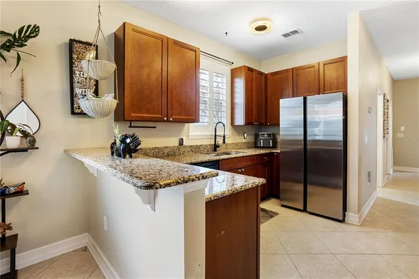a bathroom with a granite countertop sink mirror and toilet