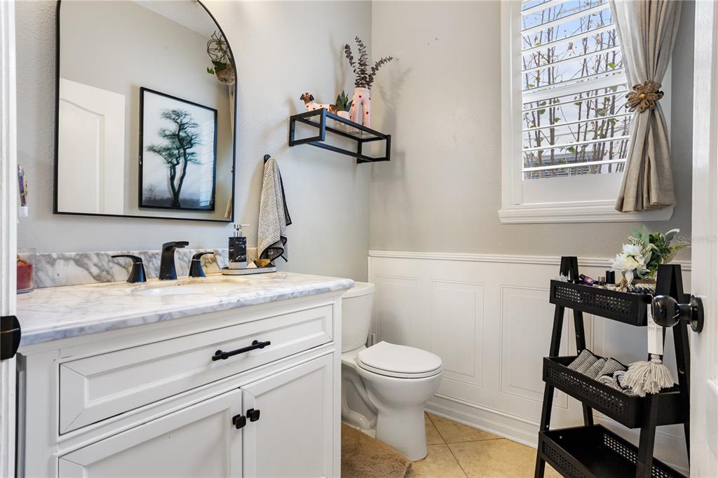 6911 Beargrass Road Harmony, FL 34773 - Photo 19 of 60 a bathroom with a granite countertop sink mirror and toilet