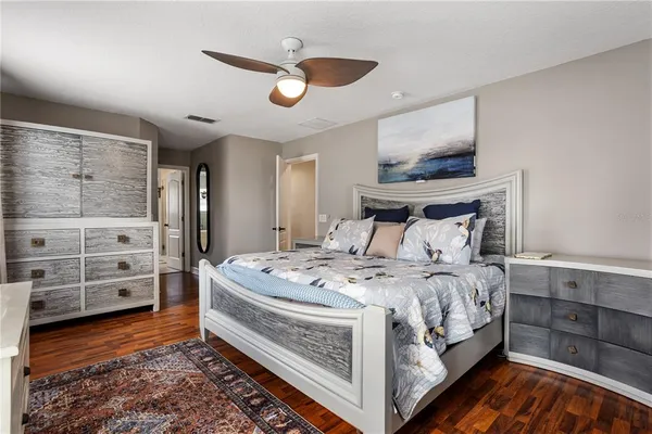 a bedroom with a large bed and a flat screen tv