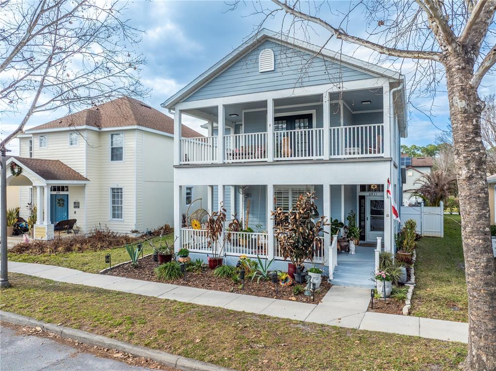 6911 Beargrass Road Harmony, FL 34773 - Photo 2 of 60 a front view of a house with garden