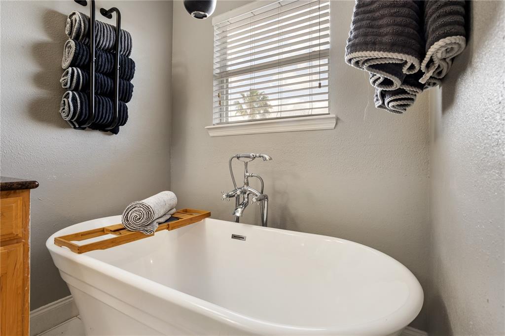 6911 Beargrass Road Harmony, FL 34773 - Photo 23 of 60 a bathroom with a white tub