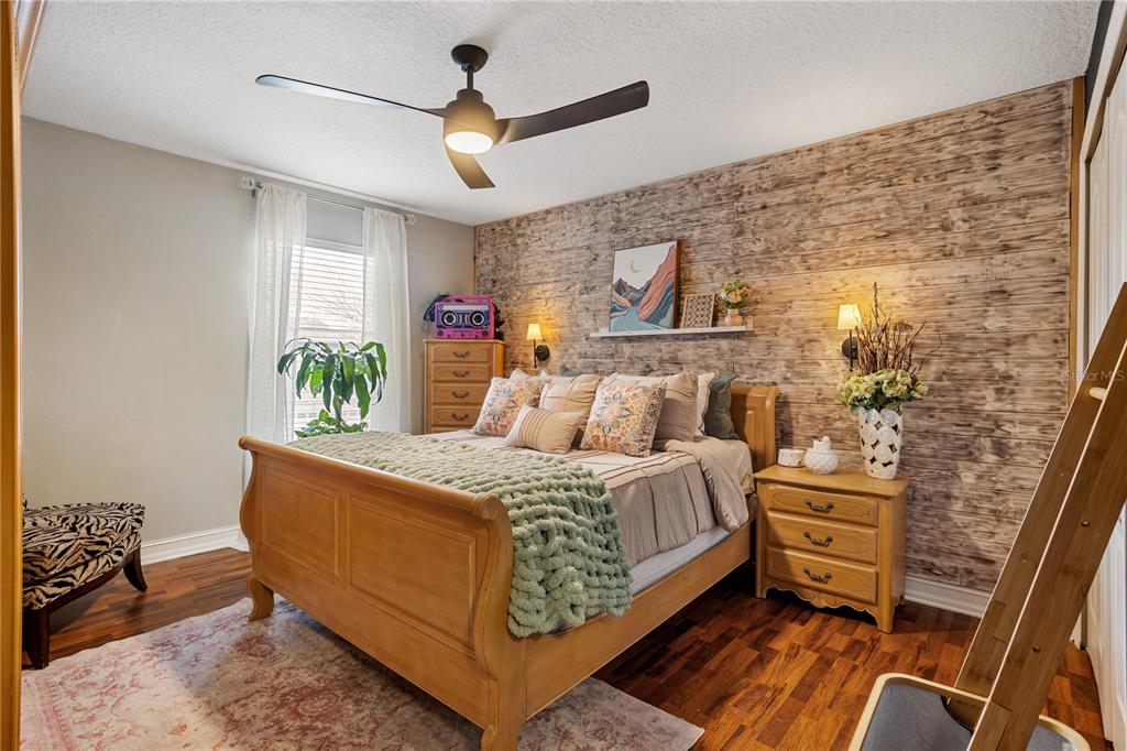 6911 Beargrass Road Harmony, FL 34773 - Photo 25 of 60 a bed room with a bed and a chandelier