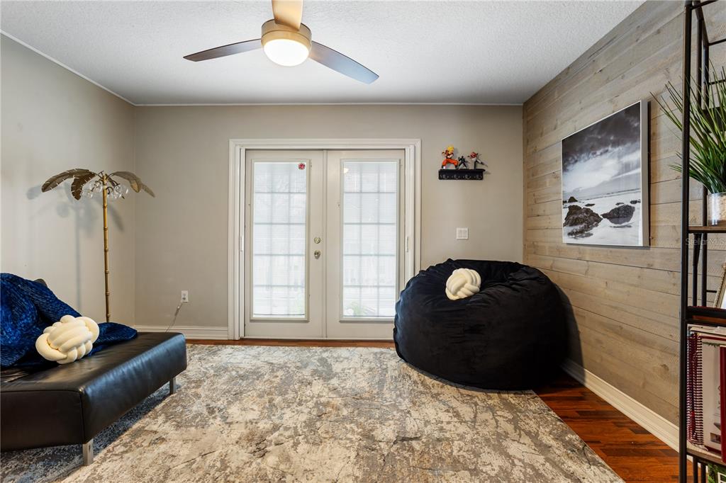 6911 Beargrass Road Harmony, FL 34773 - Photo 27 of 60 a living room with furniture and a floor to ceiling window