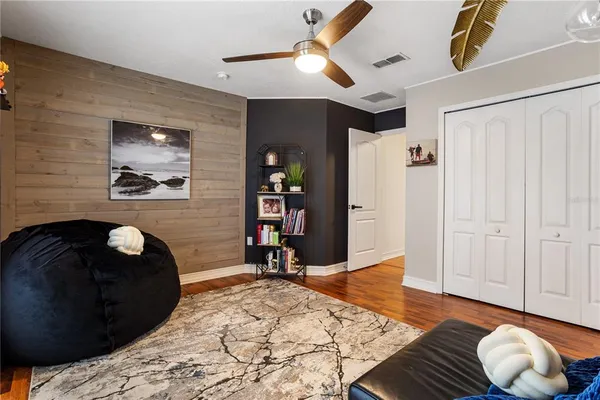 a living room with furniture and a floor to ceiling window