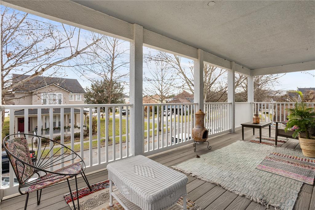 6911 Beargrass Road Harmony, FL 34773 - Photo 30 of 60 a living room with furniture and a floor to ceiling window