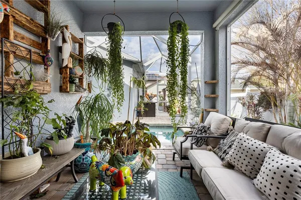 a view of a patio with table and chairs with wooden floor and fence